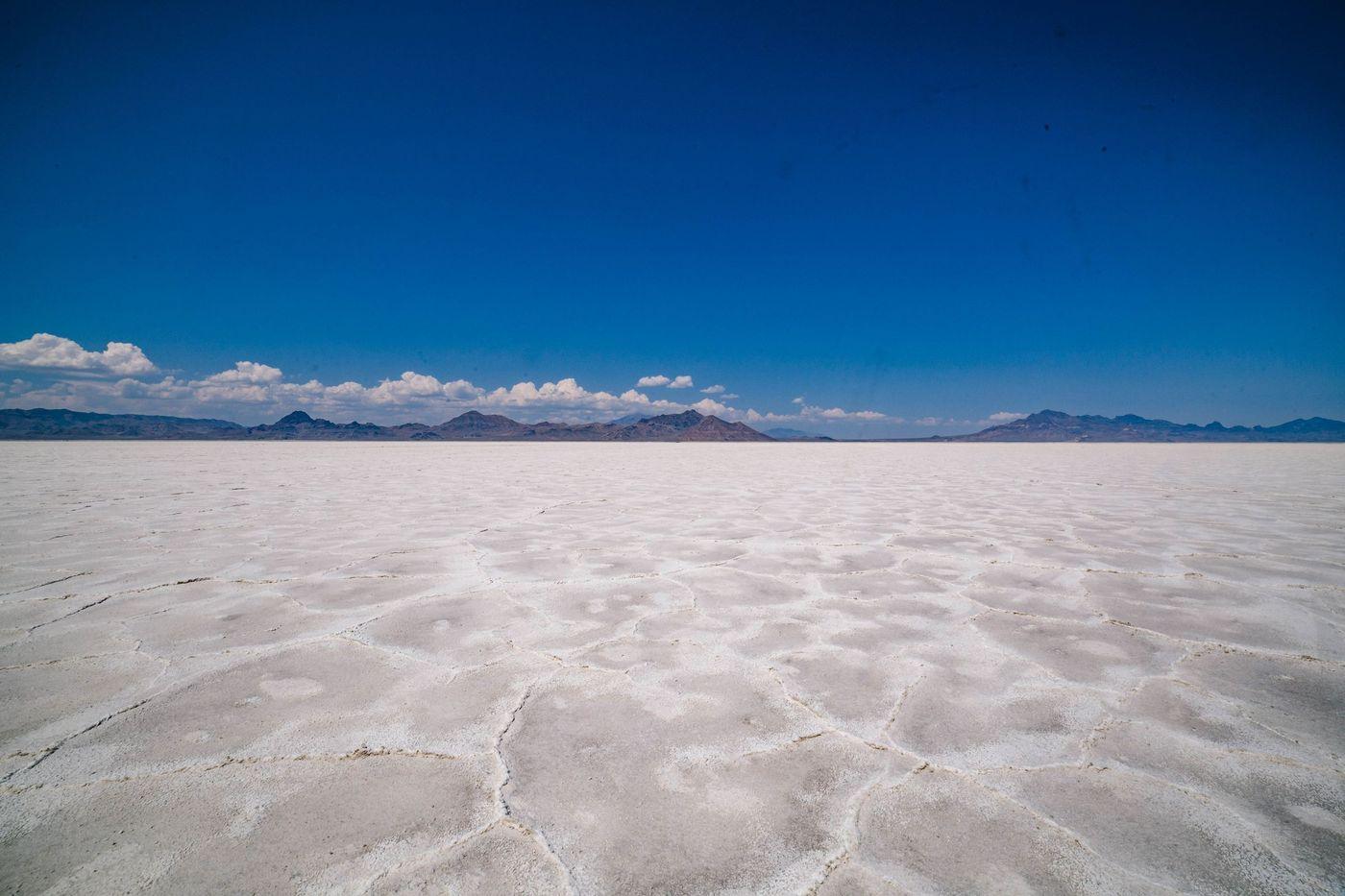 A white salt crust stretching to distant hills across a dry flat